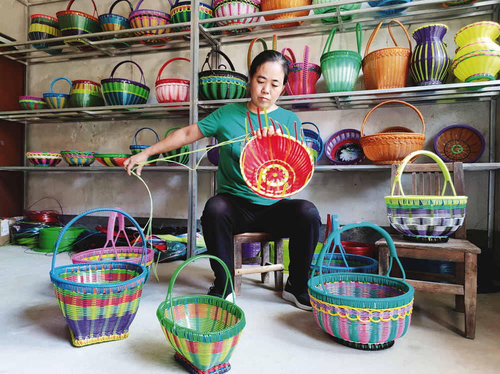 9月6日，邓玲在家中编织果篮，不大的房间里摆满了五颜六色各种类型的藤编制品。图片由朱聪提供