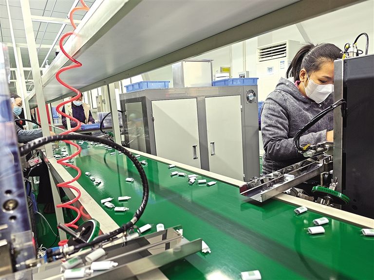 年产五千万只锂离子电池自动化生产线车间里,工人将锂离子电池加工