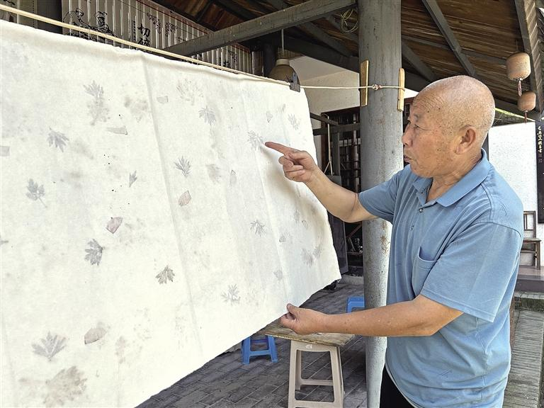 7月25日,马松胜展示创新产品“双层花叶”装饰纸。记者 甘甜 摄